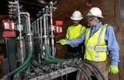 A photo of site workers inspecting an injection system